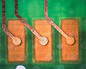 Figure 2. Examples of via and track patterns visible through the PCB. The interconnected solder pads on the top of the board are also visible.
